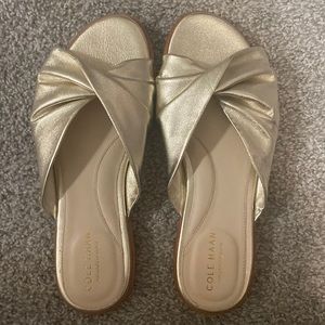 Cole Haan gold slip on sandals.